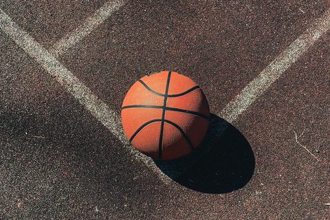A basketball on an outdoor court line